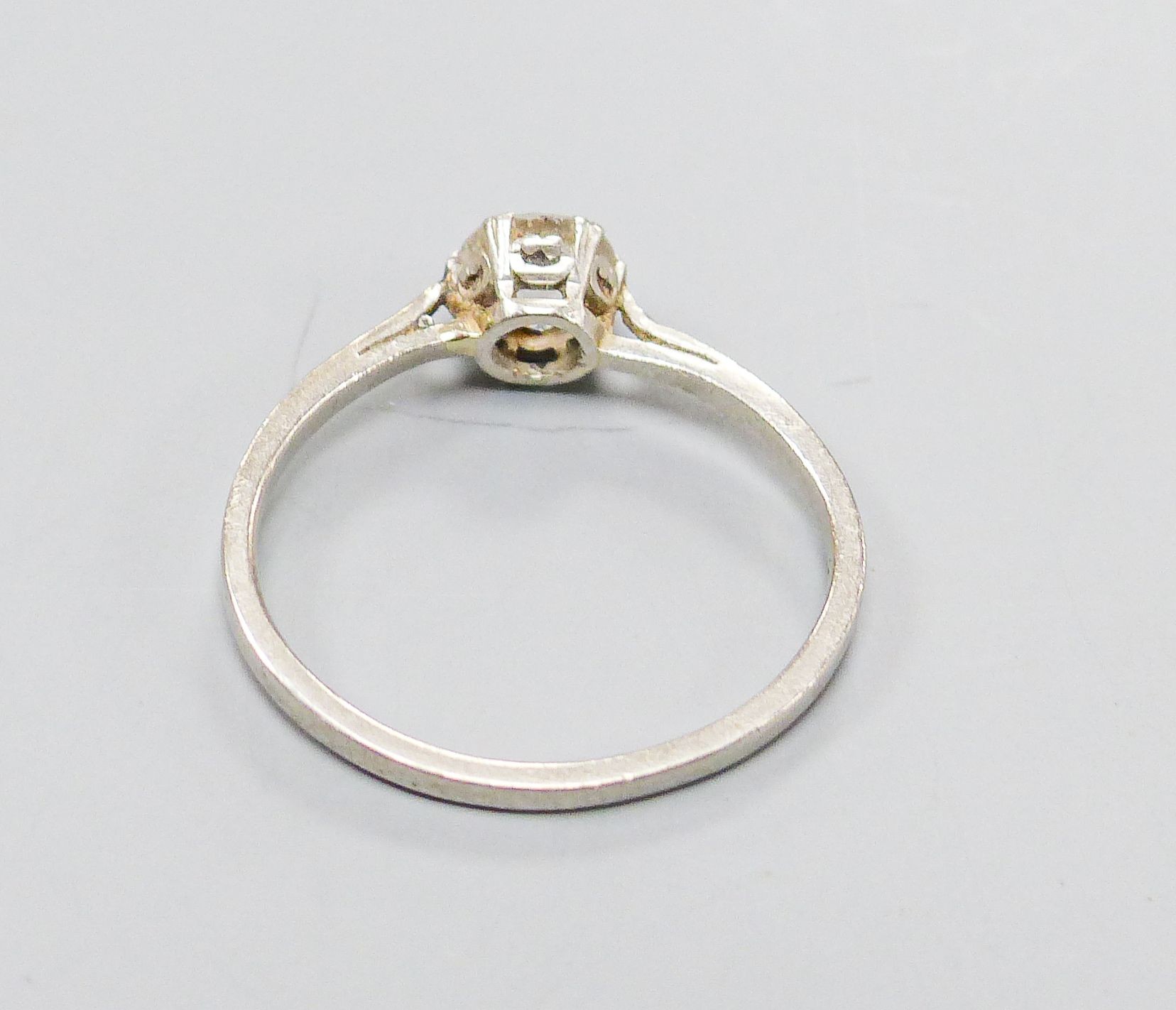 A white metal and solitaire diamond set ring, size K/L, gross weight 2.4 grams